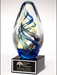Egg-shaped art glass award on black glass base